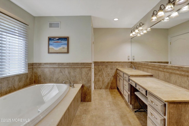 bathroom with visible vents, tile patterned flooring, vanity, and a healthy amount of sunlight