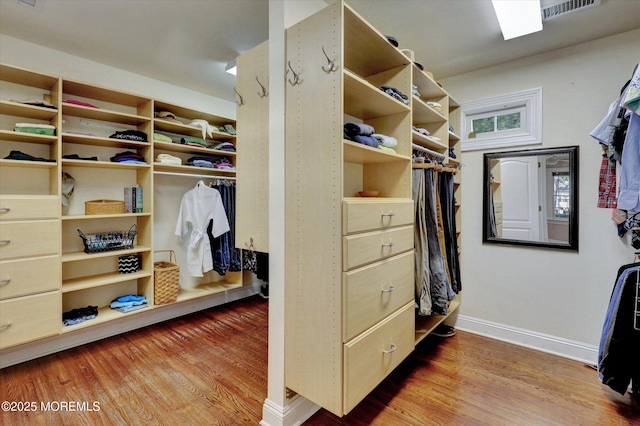 walk in closet with wood finished floors and visible vents
