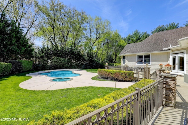 view of swimming pool with a fenced in pool, a yard, a patio area, french doors, and an in ground hot tub