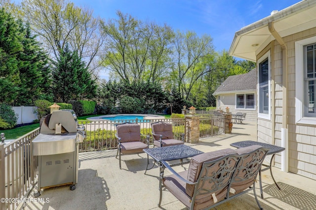 view of patio / terrace with a fenced in pool and fence