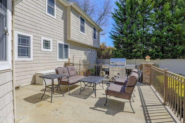 view of patio featuring fence, outdoor lounge area, and area for grilling