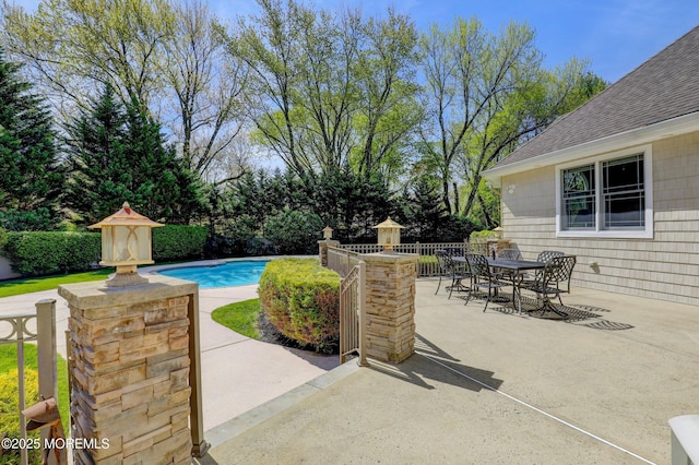 view of patio / terrace with a fenced in pool, outdoor dining space, and fence