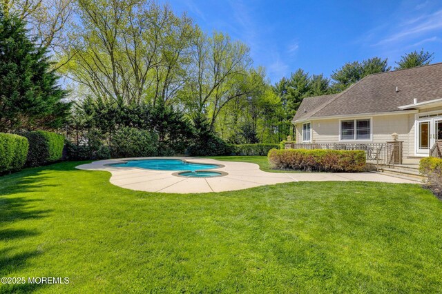 pool with a lawn and a patio