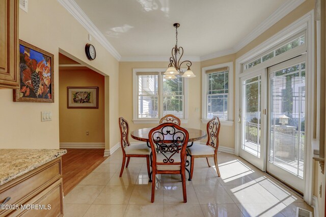 dining room featuring visible vents, a wealth of natural light, a notable chandelier, and crown molding