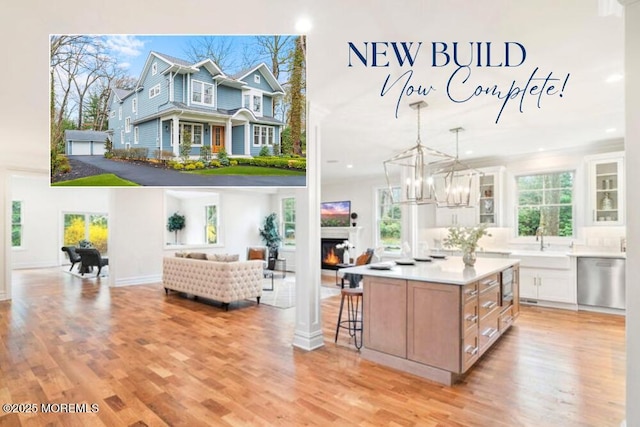 40 Circle Dr, Rumson, NJ 07760 - kitchen with dishwasher, a warm lit fireplace, glass insert cabinets, light wood finished floors, and recessed lighting