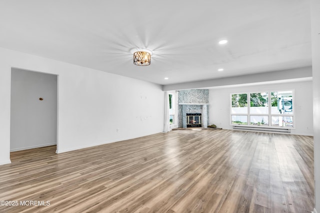35 Tara Lin Dr, Hazlet, NJ 07730 - unfurnished living room featuring wood finished floors, a fireplace, recessed lighting, a baseboard heating unit, and baseboards