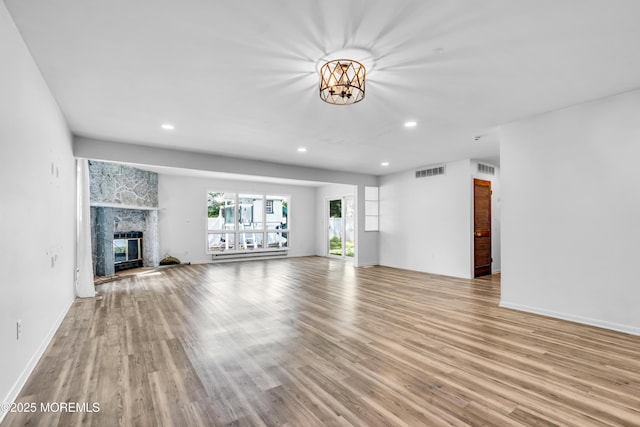 35 Tara Lin Dr, Hazlet, NJ 07730 - unfurnished living room featuring wood finished floors, recessed lighting, a chandelier, a fireplace, and baseboards