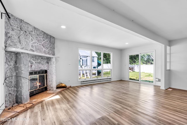 35 Tara Lin Dr, Hazlet, NJ 07730 - unfurnished living room featuring baseboard heating, a stone fireplace, wood finished floors, baseboards, and recessed lighting