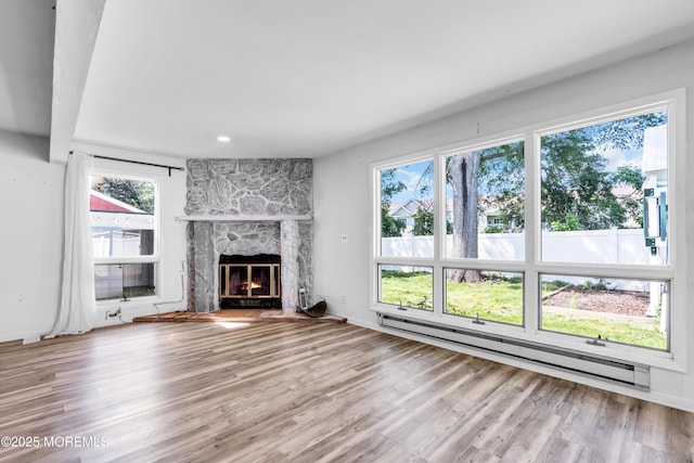 35 Tara Lin Dr, Hazlet, NJ 07730 - unfurnished living room featuring baseboard heating, plenty of natural light, and wood finished floors