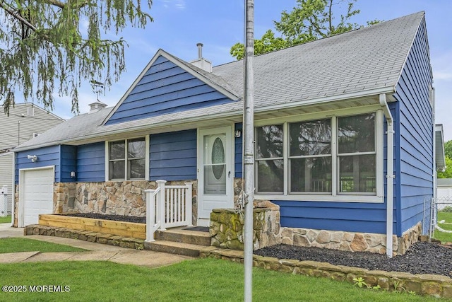 703 Stone Rd, Union Beach, NJ 07735 - view of front of house with an attached garage and stone siding