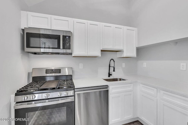 703 Stone Rd, Union Beach, NJ 07735 - kitchen featuring stainless steel appliances, a sink, and white cabinets
