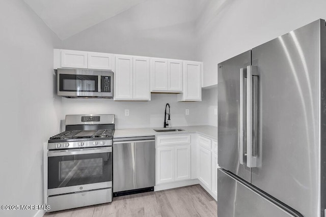 703 Stone Rd, Union Beach, NJ 07735 - kitchen with appliances with stainless steel finishes, a sink, light countertops, white cabinets, and lofted ceiling