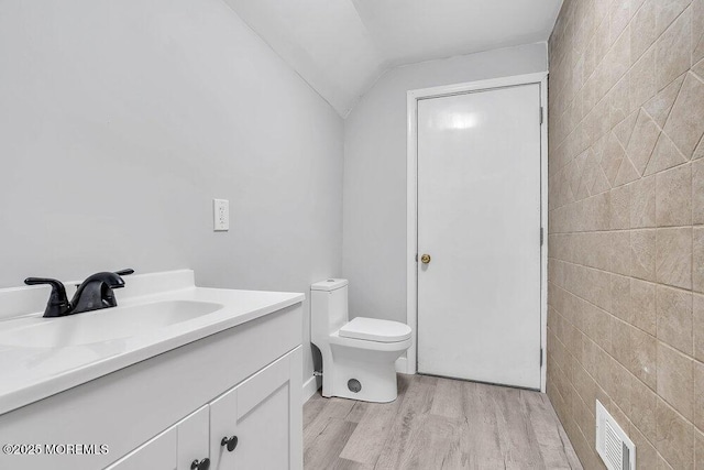 703 Stone Rd, Union Beach, NJ 07735 - bathroom featuring wood finished floors, vanity, toilet, and vaulted ceiling