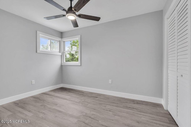 703 Stone Rd, Union Beach, NJ 07735 - unfurnished bedroom featuring baseboards, wood finished floors, a closet, and a ceiling fan