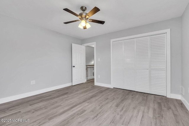 703 Stone Rd, Union Beach, NJ 07735 - unfurnished bedroom featuring baseboards, wood finished floors, a closet, and ceiling fan