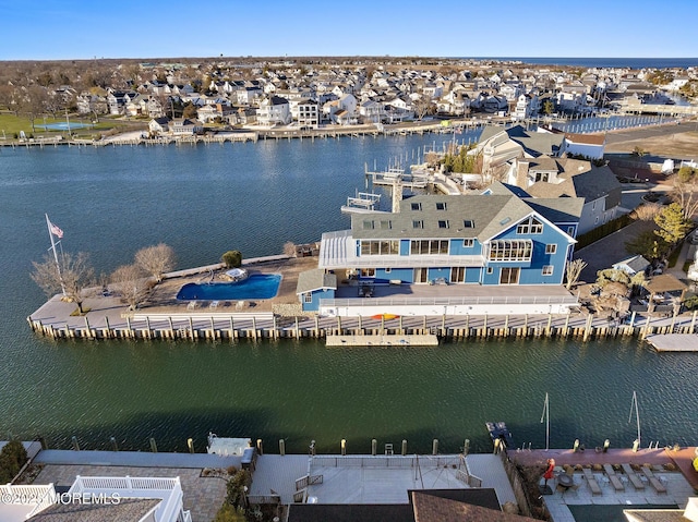 drone / aerial view featuring a water view and a residential view