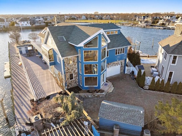 drone / aerial view featuring a residential view and a water view