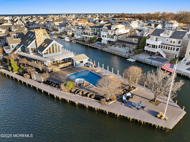 birds eye view of property with a residential view and a water view