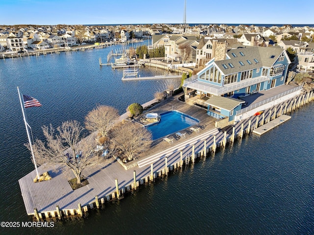 bird's eye view with a water view and a residential view