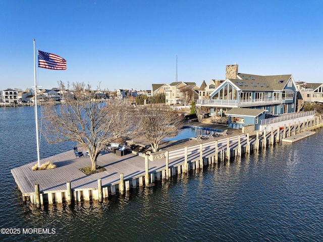 dock area with a residential view and a water view