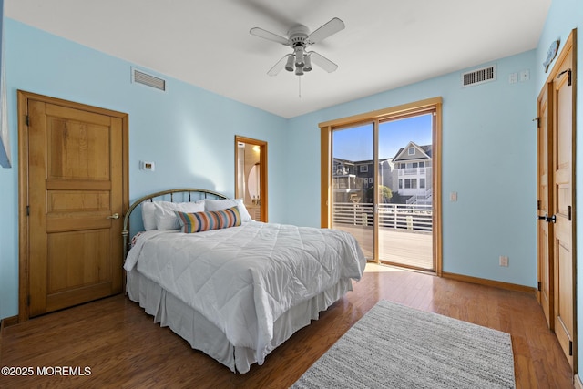 bedroom featuring baseboards, visible vents, wood finished floors, and access to outside