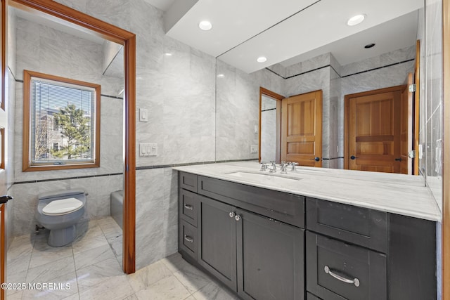 full bathroom with vanity, tile walls, recessed lighting, toilet, and marble finish floor