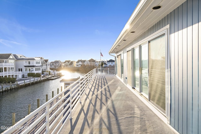 balcony with a water view and a residential view