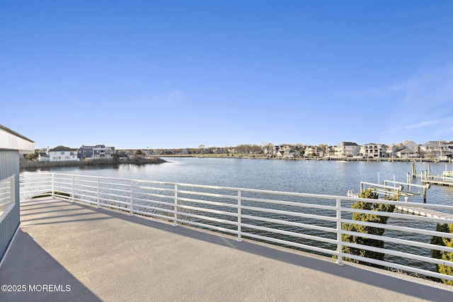 exterior space with a dock and a water view