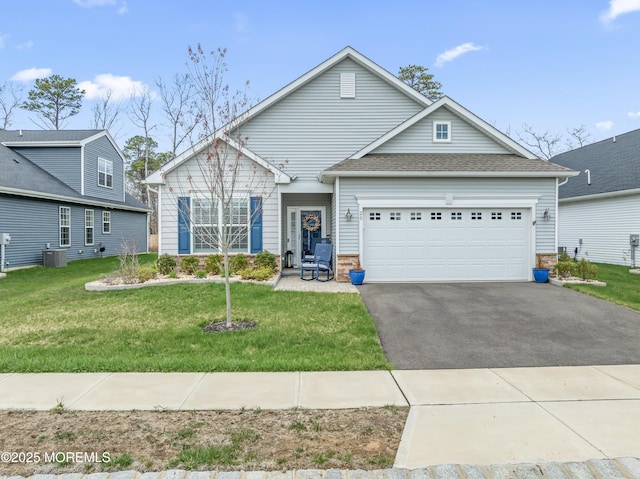 view of front facade with driveway, an attached garage, and a front lawn