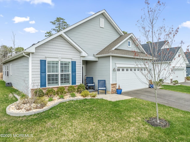 view of front of property featuring driveway, a garage, and a front lawn