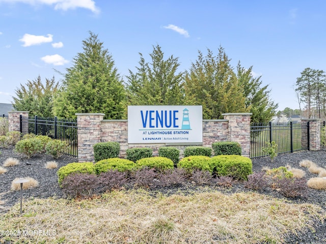 community sign featuring fence