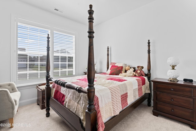 carpeted bedroom featuring baseboards and visible vents