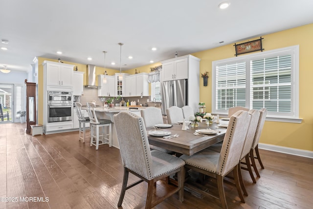 dining area with dark wood-type flooring, recessed lighting, and plenty of natural light