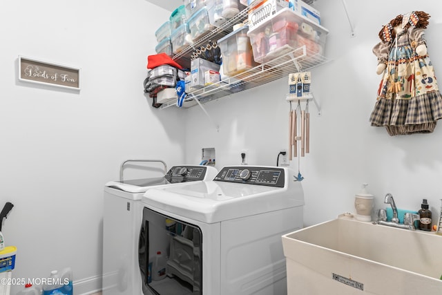 laundry room with independent washer and dryer, laundry area, and a sink