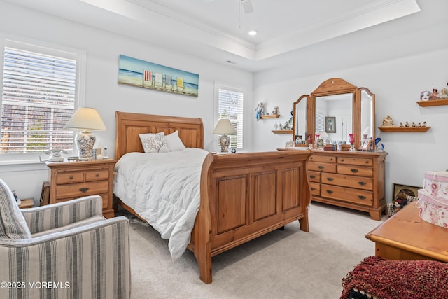bedroom featuring ceiling fan, a tray ceiling, ornamental molding, recessed lighting, and light carpet