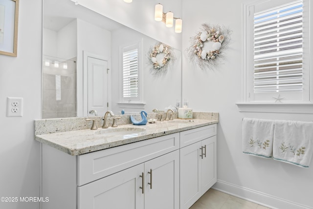 full bathroom with tile patterned flooring, double vanity, baseboards, and a sink