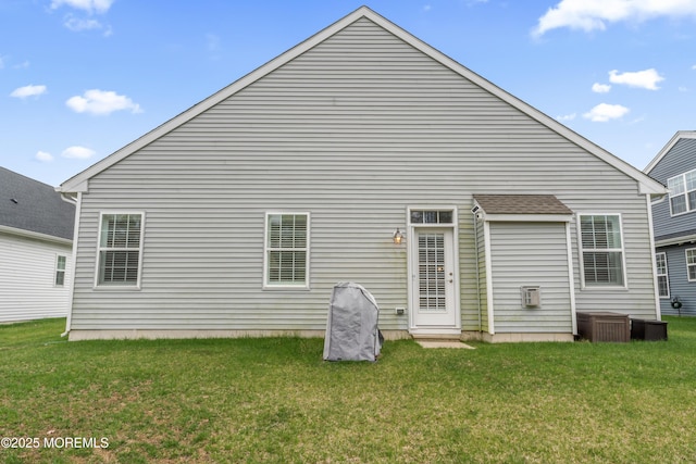 back of property featuring a lawn