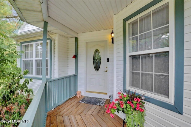 view of exterior entry featuring covered porch