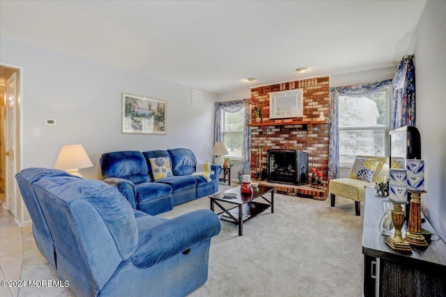 living room with light tile patterned floors, a brick fireplace, and light carpet