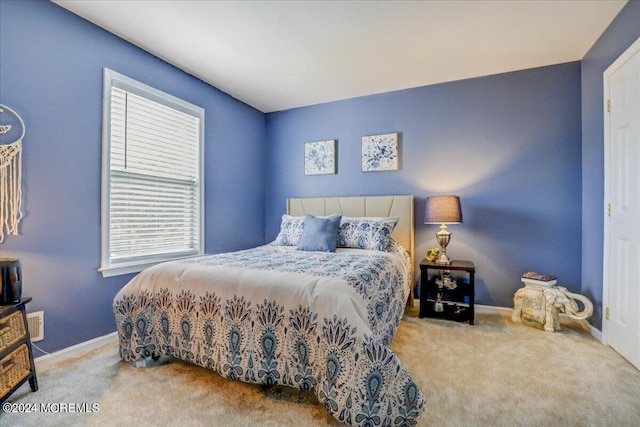 bedroom featuring baseboards and carpet