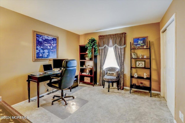 carpeted home office featuring baseboards