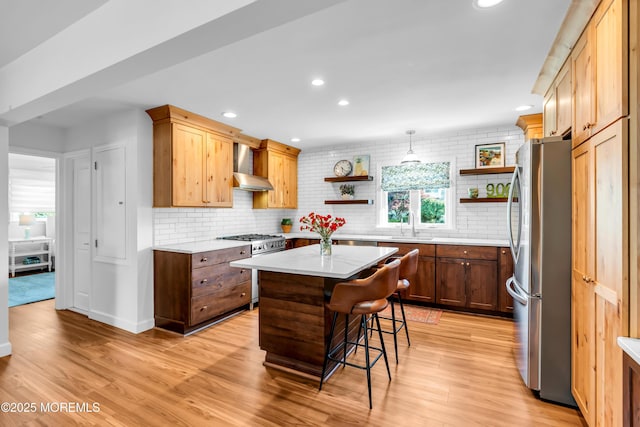 kitchen with appliances with stainless steel finishes, open shelves, light wood-style floors, and recessed lighting