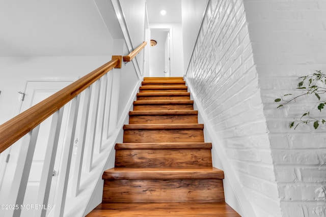 stairway with wood finished floors
