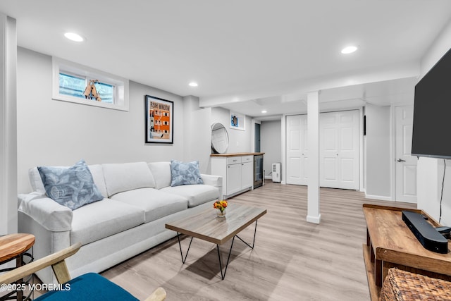 living room with light wood-style floors and recessed lighting