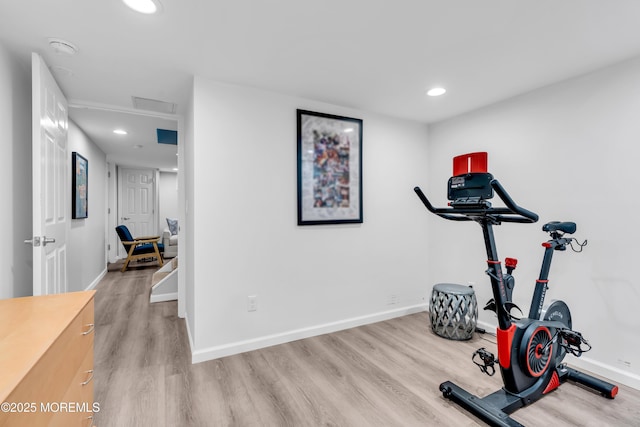 exercise room with light wood-type flooring, baseboards, and recessed lighting