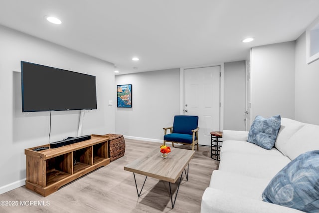 living room with wood finished floors, baseboards, and recessed lighting
