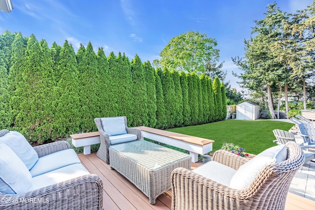 deck with an outdoor living space, a storage shed, a yard, and an outdoor structure