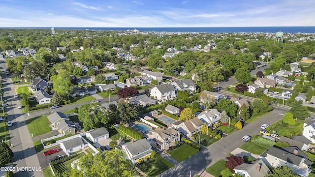 aerial view of property and surrounding area featuring nearby suburban area