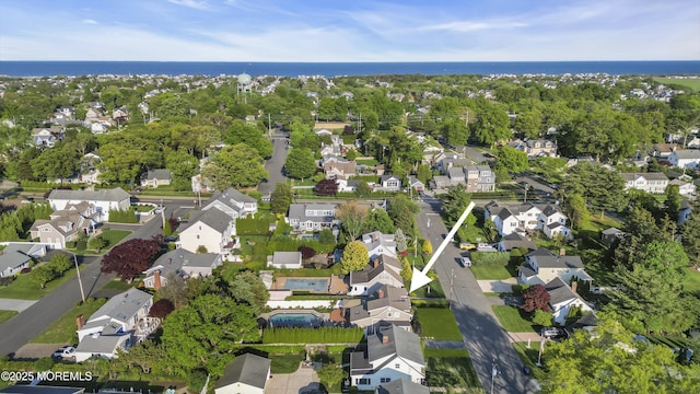 aerial view of property's location featuring nearby suburban area and a nearby body of water