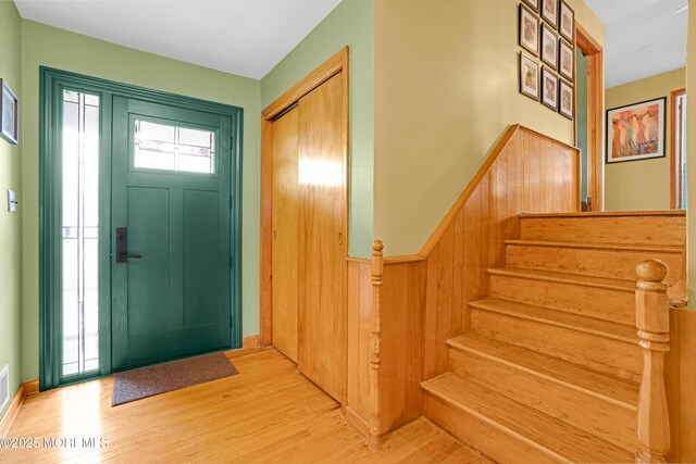 foyer featuring stairway and light wood-type flooring